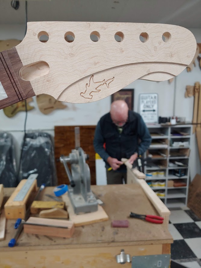 Fueler headstock and Dan working on a neck