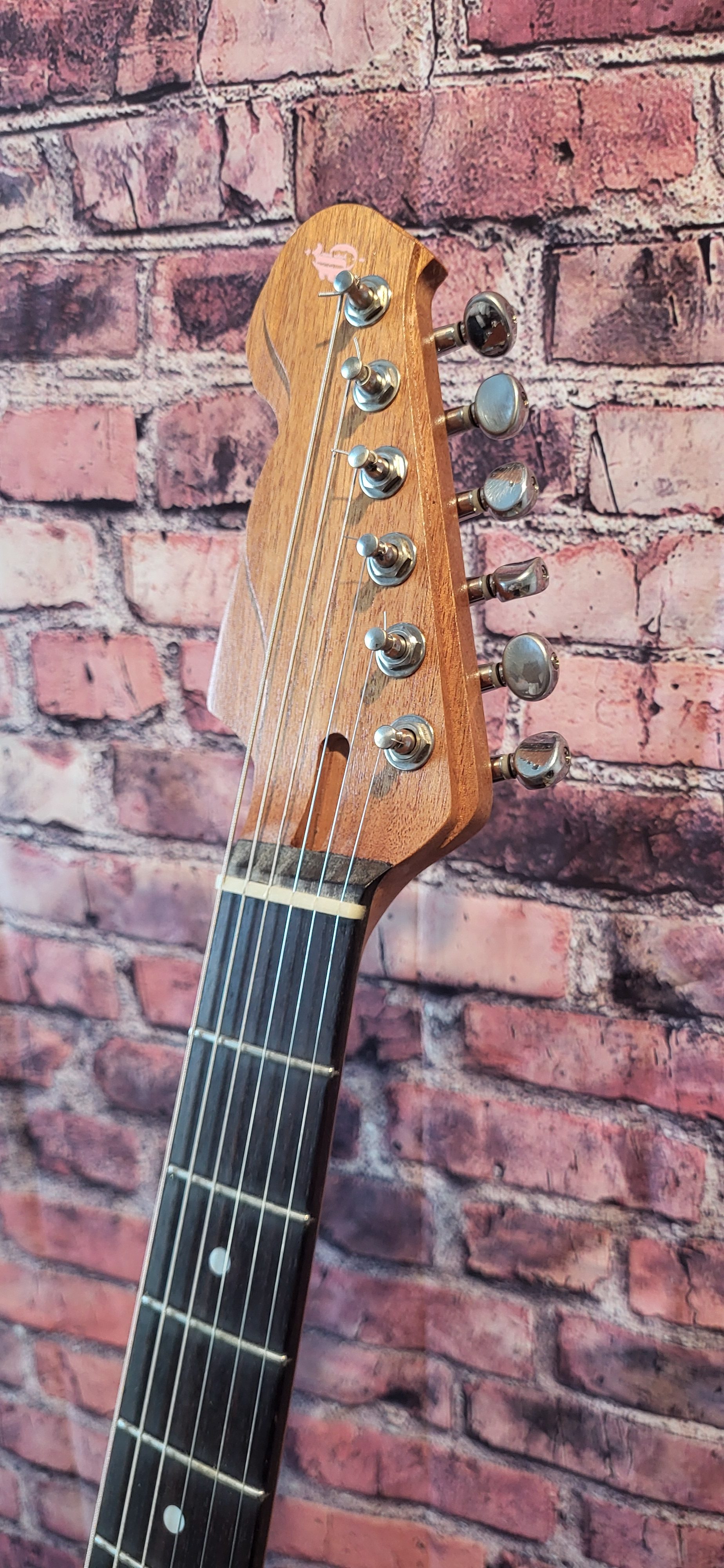 Oiler Pink Sunburst Headstock Quar Angle